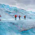 Four people walking on Mendenhall Glacier, Alaska, USA