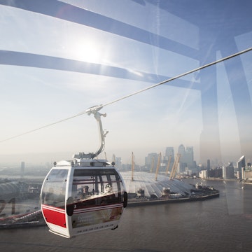 Emirates Air Line cable car crossing Thames from Royal Docks to Greenwich Peninsula.