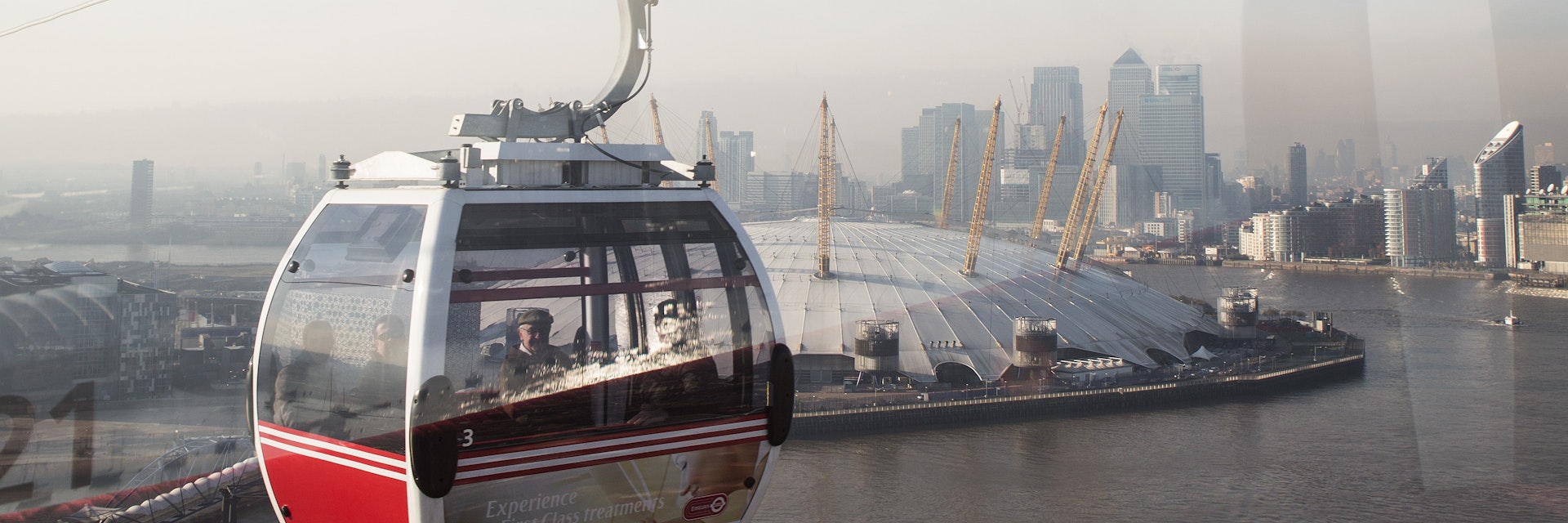 Emirates Air Line cable car crossing Thames from Royal Docks to Greenwich Peninsula.