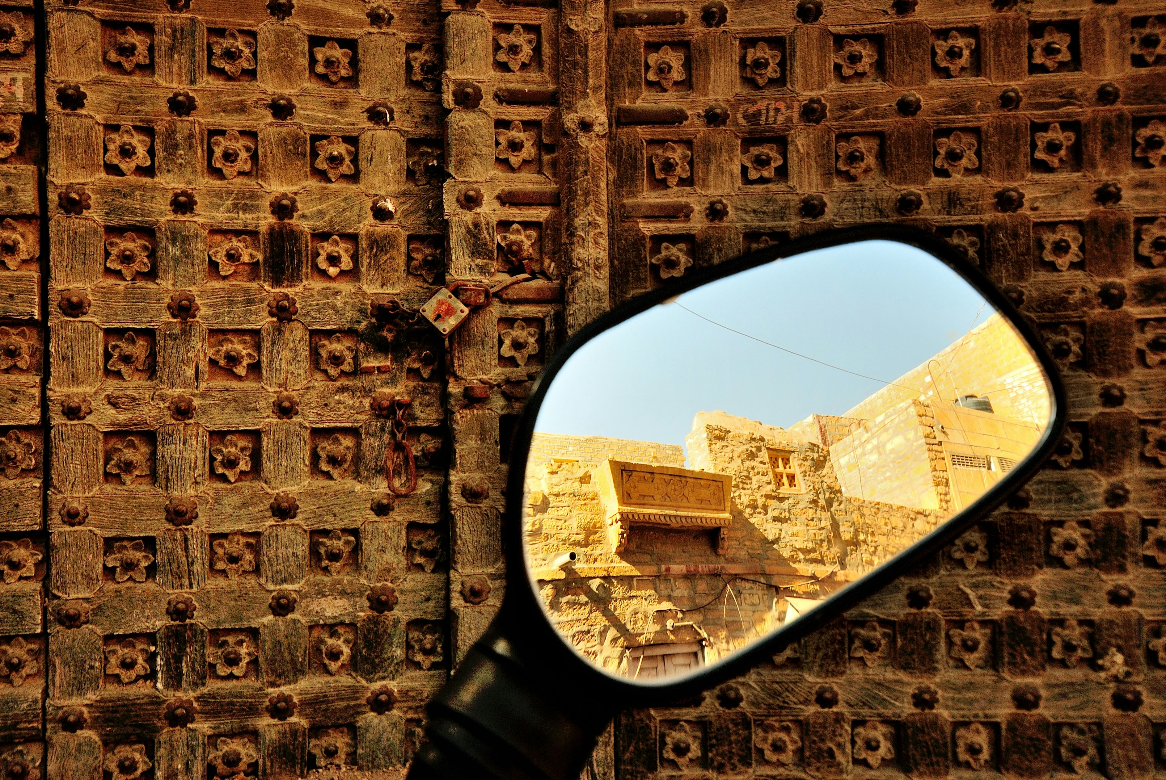 500px Photo ID: 71843661 - Jaisalmer is a unique place, with the majority of the population of the dusty desert town still residing inside the centuries old fort. Making it the Living Fort. Cars, bikes can be driven inside the narrow lanes of the fort. At one point one gets to see an old ruin and  standing tall next to it is a Harley Davidson at the entrance of one of the many Fort restaurants.