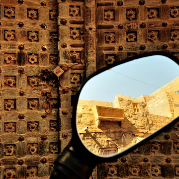 500px Photo ID: 71843661 - Jaisalmer is a unique place, with the majority of the population of the dusty desert town still residing inside the centuries old fort. Making it the Living Fort. Cars, bikes can be driven inside the narrow lanes of the fort. At one point one gets to see an old ruin and standing tall next to it is a Harley Davidson at the entrance of one of the many Fort restaurants.