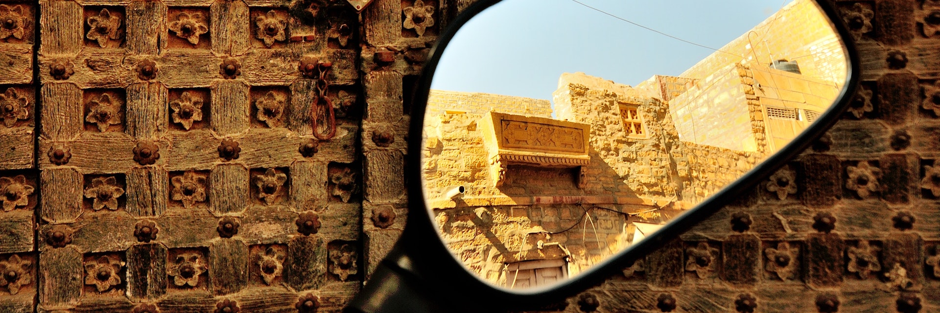 500px Photo ID: 71843661 - Jaisalmer is a unique place, with the majority of the population of the dusty desert town still residing inside the centuries old fort. Making it the Living Fort. Cars, bikes can be driven inside the narrow lanes of the fort. At one point one gets to see an old ruin and  standing tall next to it is a Harley Davidson at the entrance of one of the many Fort restaurants.