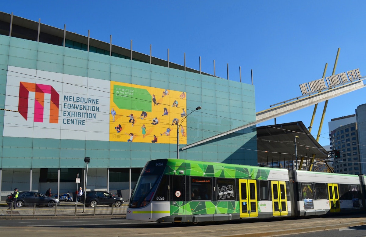 Entrance of the Melbourne Exhibition Centre with tram going by.