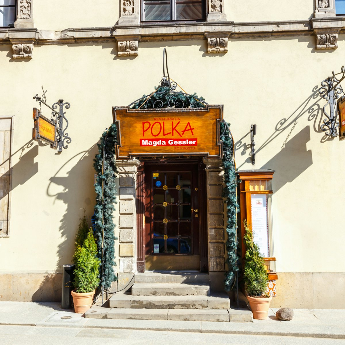 WARSAW, POLAND, 13 march 2016: Restaurant in old town in Warsaw in a sunny day. Warsaw is the capital of Poland; Shutterstock ID 393660925; Your name (First / Last): Lauren Gillmore; GL account no.: 56530; Netsuite department name: Online-Design; Full Product or Project name including edition: 65050/ Online Design /LaurenGillmore/POI