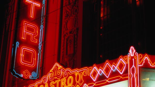 Colourful neon signs outside the Castro Theater at night.