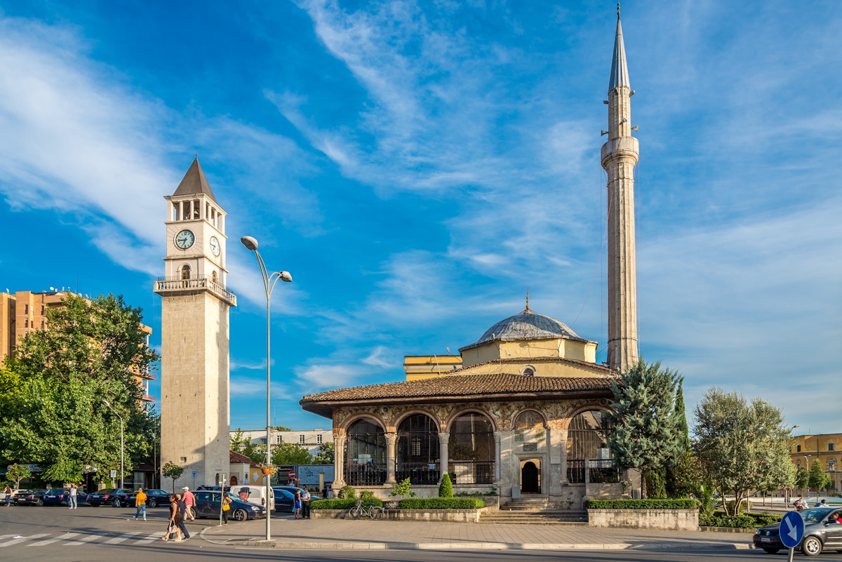 TIRANA, ALBANIA - JULY 29,2014 - Et'hem Bey Mosque and Tirana Clock Tower. Tirana is capital of Albania.; Shutterstock ID 210373570; Your name (First / Last): Brana Vladisavljevic; GL account no.: 65050; Netsuite department name: Online Editorial; Full Product or Project name including edition: Tirana BiE 2018
