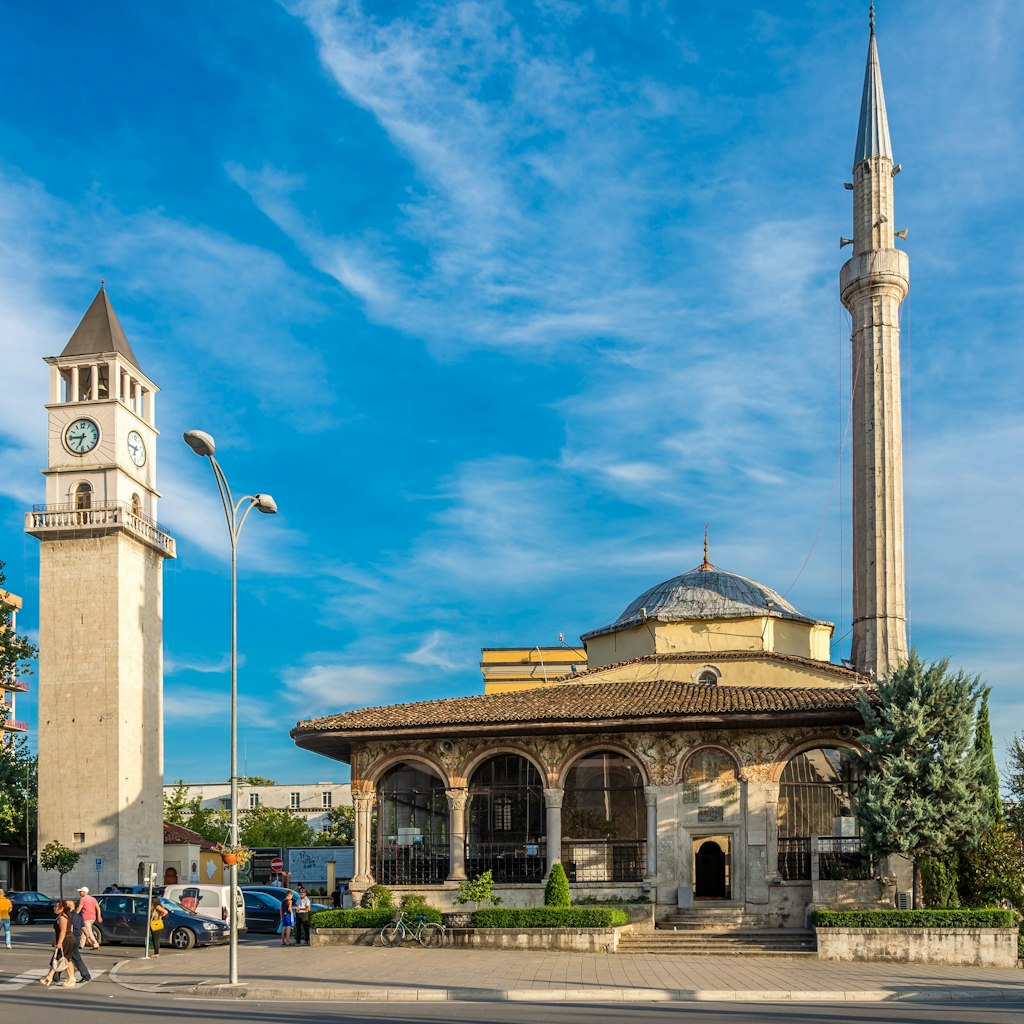 TIRANA, ALBANIA - JULY 29,2014 - Et'hem Bey Mosque and Tirana Clock Tower. Tirana is capital of Albania.; Shutterstock ID 210373570; Your name (First / Last): Brana Vladisavljevic; GL account no.: 65050; Netsuite department name: Online Editorial; Full Product or Project name including edition: Tirana BiE 2018