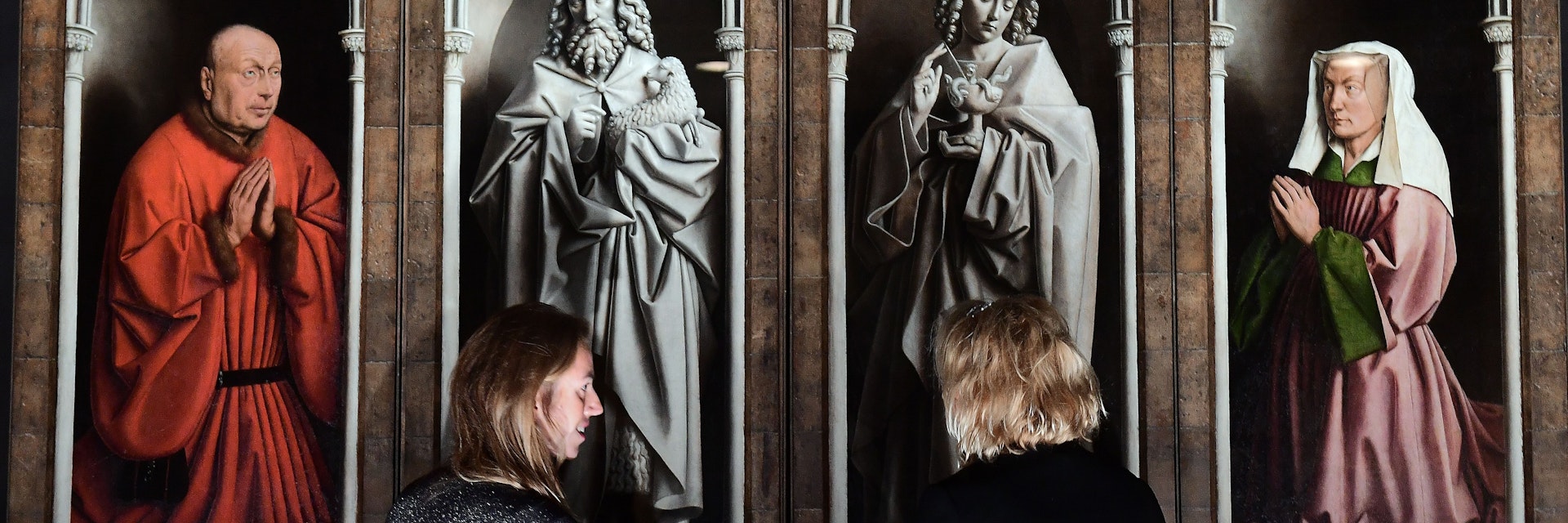 Officials unveil the restored exterior panels of "The Adoration of the Mystic Lamb", an altar piece painted by the Van Eyck brothers in 1432, at Saint Bavo Cathedral in Ghent on October 12, 2016. .The restoration of the exterior panels and frames started in 2012, and constitutes the first phase of restauration which will be followed by two other phases for the interior panels and is set to last until 2020. / AFP / EMMANUEL DUNAND        (Photo credit should read EMMANUEL DUNAND/AFP/Getty Images)