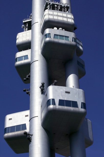 Zizkov TV Tower adorned with crawling baby sculptures.