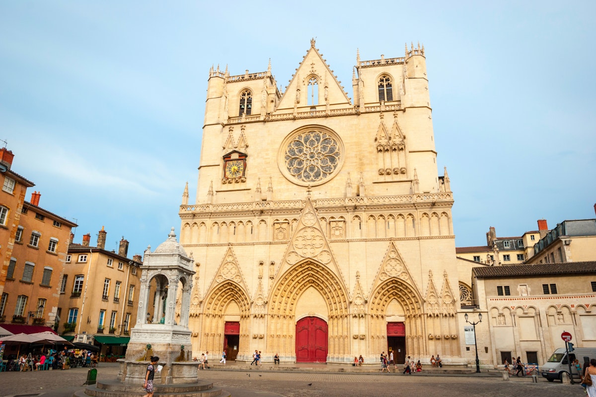 LYON, FRANCE - JUNE 5: Exterior of St. John the Baptist cathedal in Lyon downtown with people passing by. June 2015; Shutterstock ID 405341626; Your name (First / Last): Daniel Fahey; GL account no.: 65050; Netsuite department name: Online Editorial; Full Product or Project name including edition: Lyon BiT