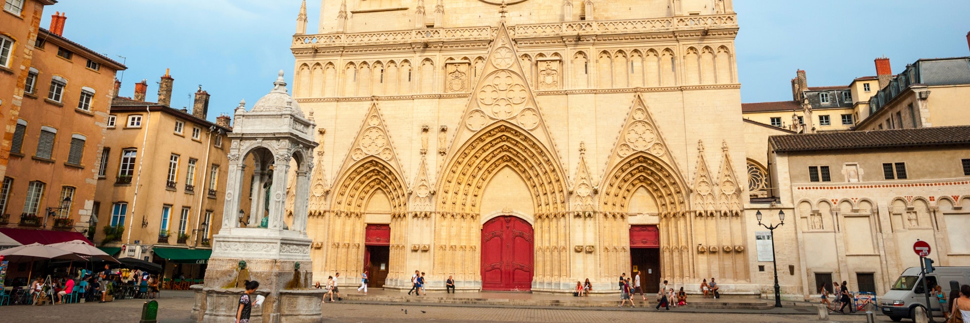 LYON, FRANCE - JUNE 5: Exterior of St. John the Baptist cathedal in Lyon downtown with people passing by. June 2015; Shutterstock ID 405341626; Your name (First / Last): Daniel Fahey; GL account no.: 65050; Netsuite department name: Online Editorial; Full Product or Project name including edition: Lyon BiT