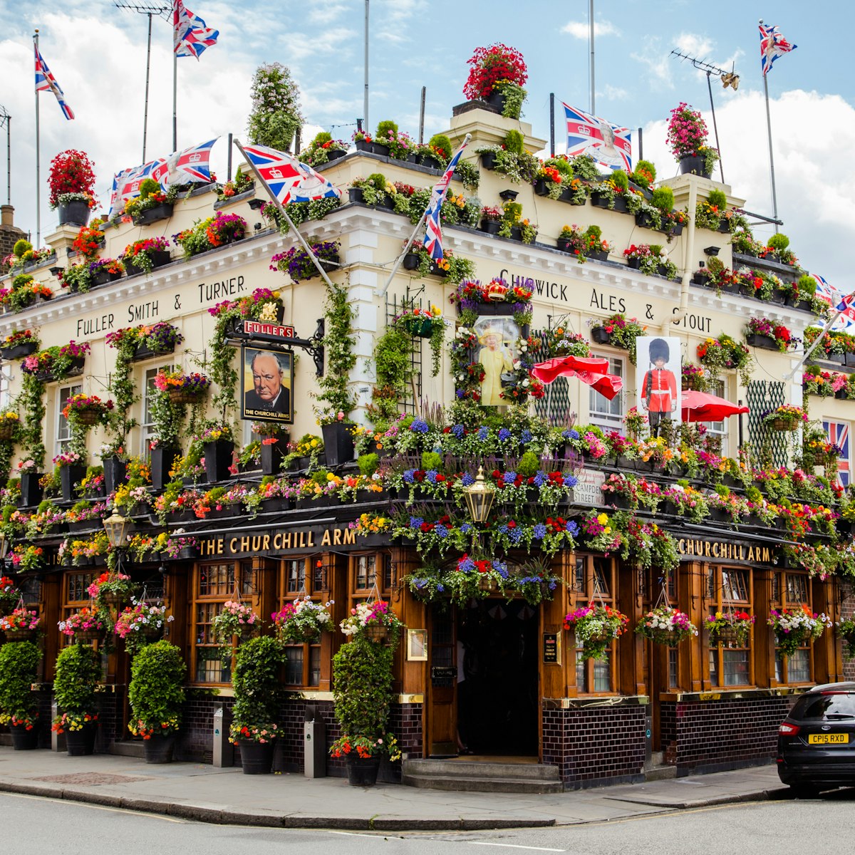 LONDON, UK - 28TH JUNE 2016: A view of the outside of the Churchill Arms in London. Large amounts of flowers and UK decorations can be seen on the exterior.; Shutterstock ID 449355649; Your name (First / Last): Lauren Gillmore; GL account no.: 56530; Netsuite department name: o; Full Product or Project name including edition: 65050/ Online Design /LaurenGillmore/POI