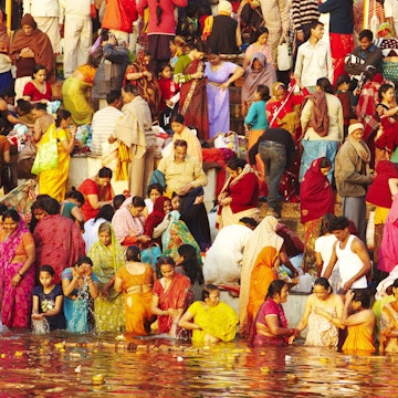 Crowd of people bathing in the Ganges.