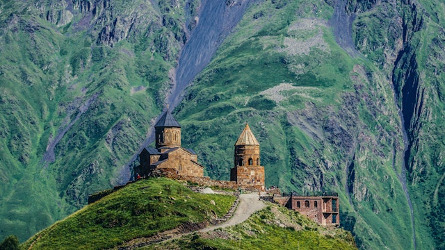Gergeti, Georgia - July 20, 2015. One of the foremost Georgian landmarks - Tsminda Sameba church (english: Holy Trinity) near Gergeti town; Shutterstock ID 446367901; Your name (First / Last): Gemma Graham; GL account no.: 65050; Netsuite department name: Online Editorial; Full Product or Project name including edition: Georgia destination page masthead and POI images