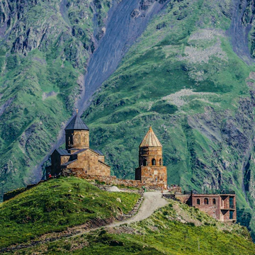 Gergeti, Georgia - July 20, 2015. One of the foremost Georgian landmarks - Tsminda Sameba church (english: Holy Trinity) near Gergeti town; Shutterstock ID 446367901; Your name (First / Last): Gemma Graham; GL account no.: 65050; Netsuite department name: Online Editorial; Full Product or Project name including edition: Georgia destination page masthead and POI images