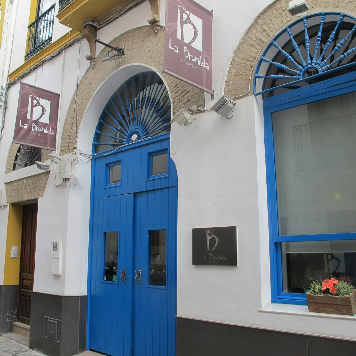 La Brunilda, blue door and window with signs