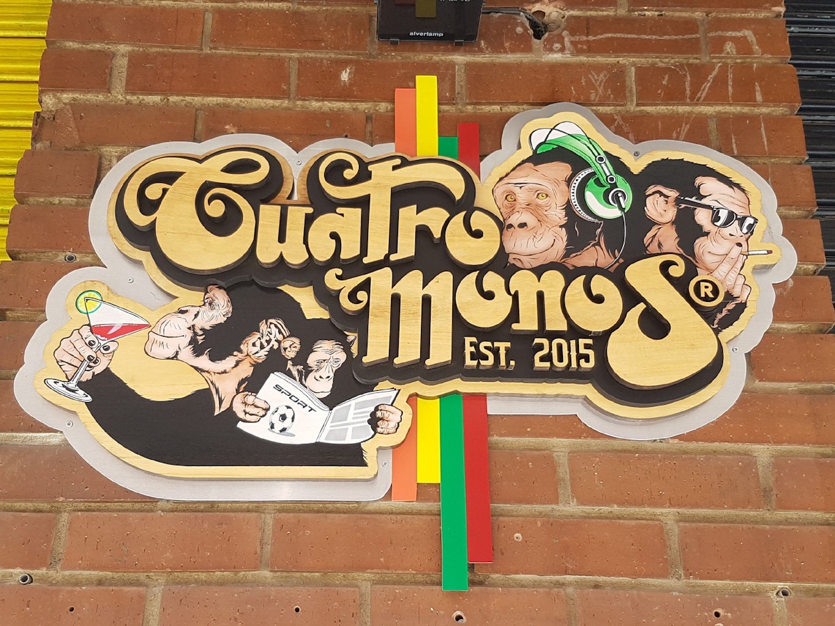 Cuatro Monos sign outside the bar.