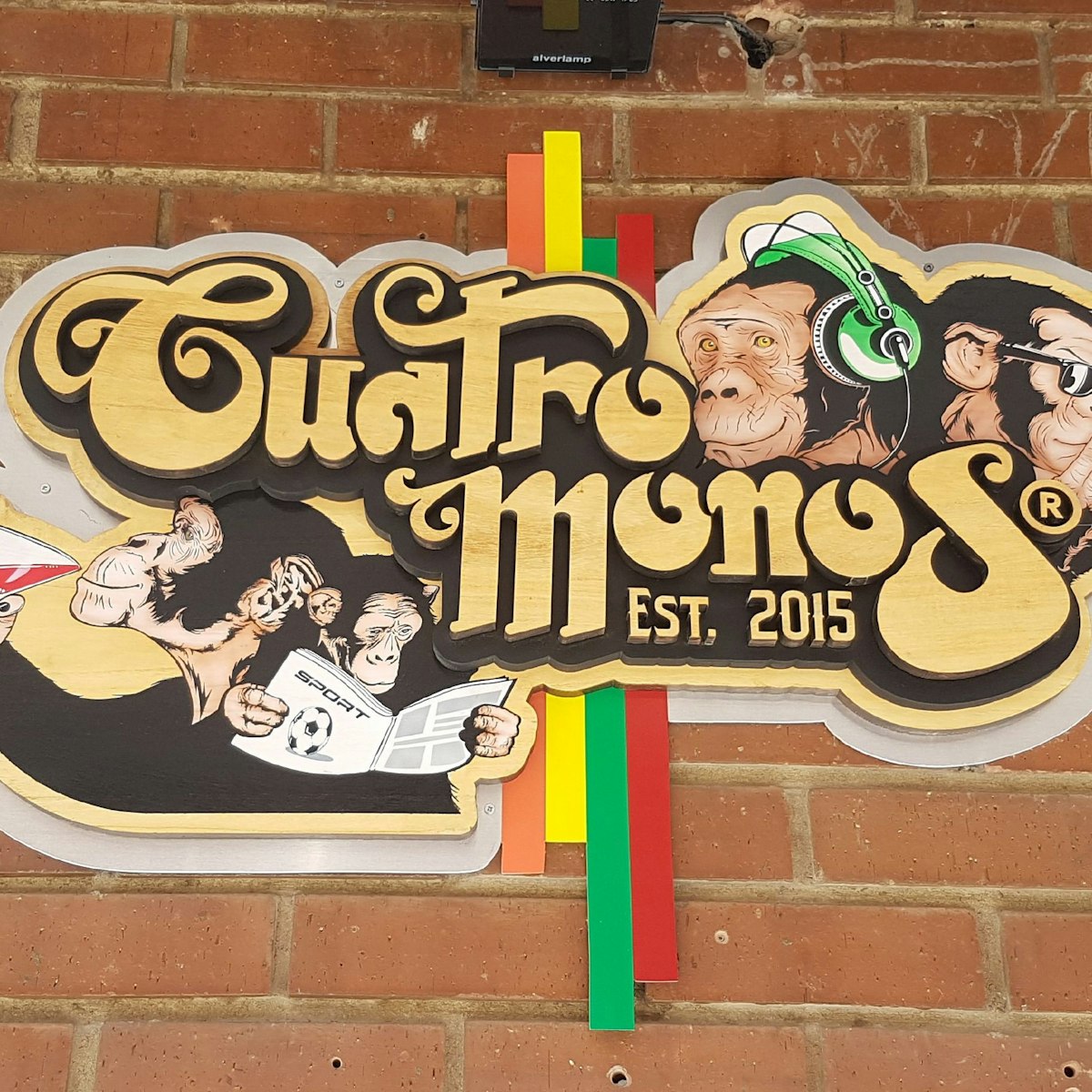 Cuatro Monos sign outside the bar.