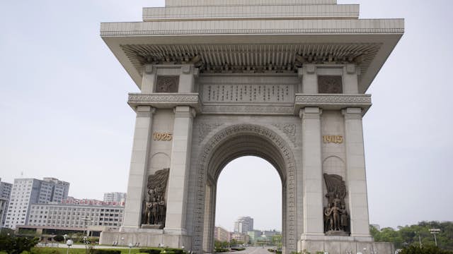 North Korea, Pyongyang. Arch of Triumph with deserted road which was erected in 1982 for Kim Il Sungs 70th birthday