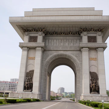 North Korea, Pyongyang. Arch of Triumph with deserted road which was erected in 1982 for Kim Il Sungs 70th birthday