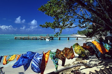 Sandy beach, colorful scarves, sarongs, Pigeon Point, Tobago, West Indies, Caribbean