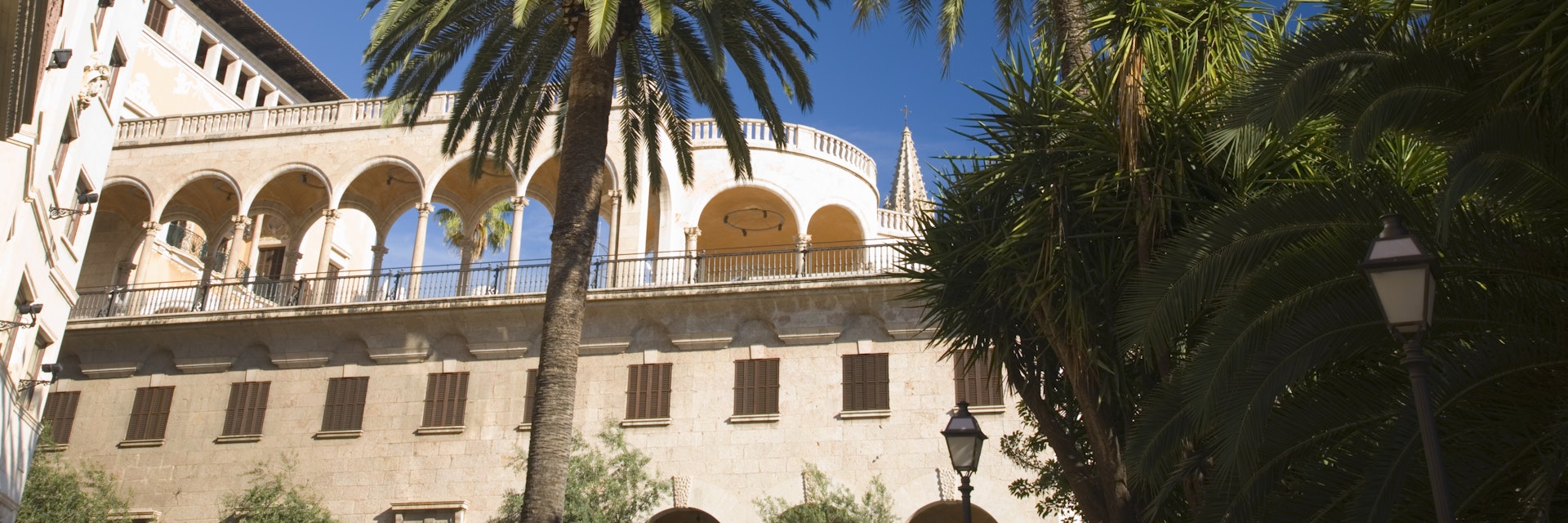Palau March, a private palace now used as a modern art gallery, with palm trees in foreground.