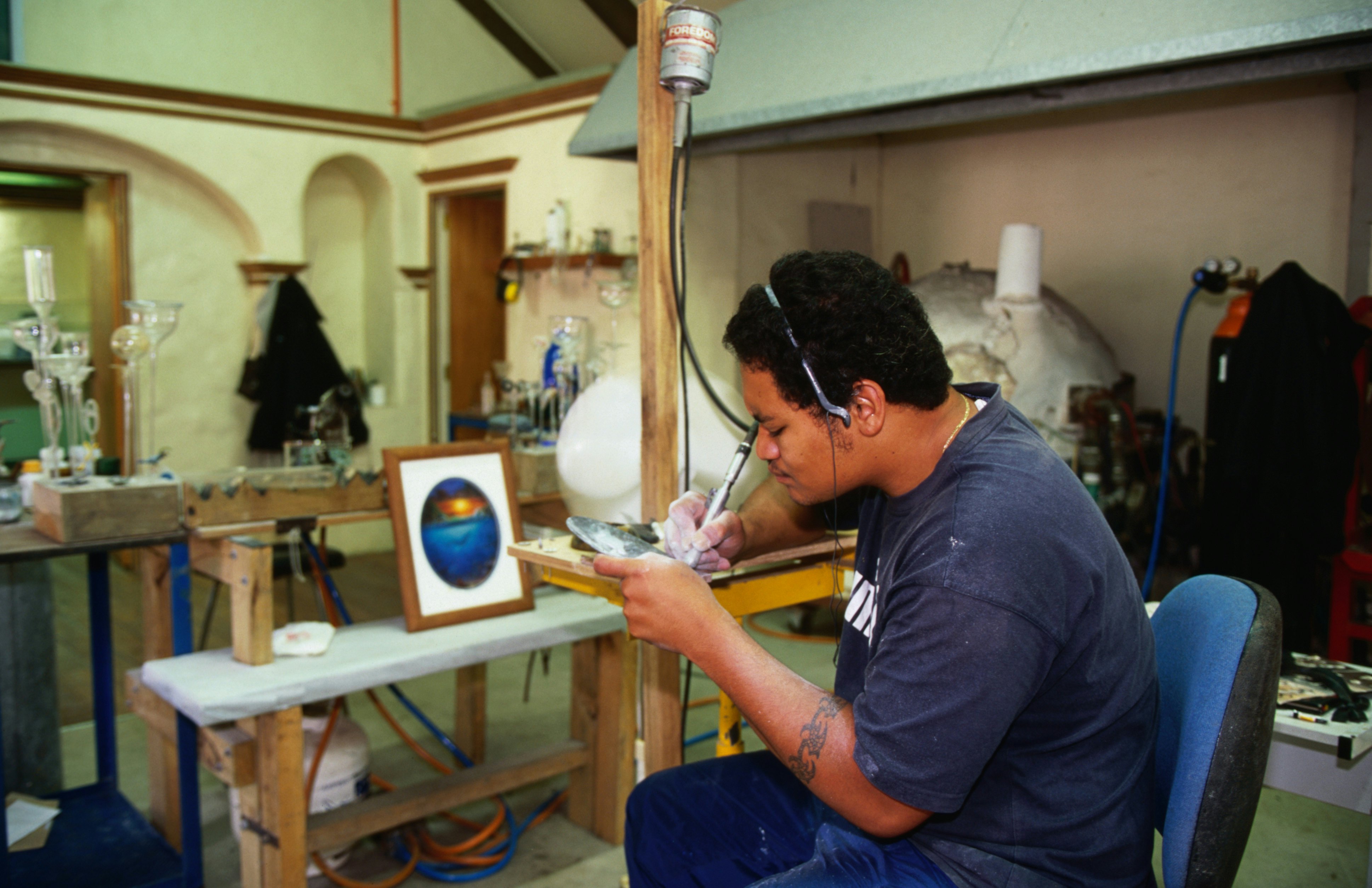 Local engraver at work in the workshop at the Beachcomber Gallery in Avarua.