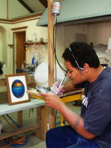 Local engraver at work in the workshop at the Beachcomber Gallery in Avarua.