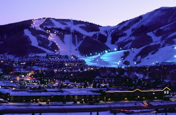 Overhead of Park City Ski Resort and ski runs, illuminated at dusk.