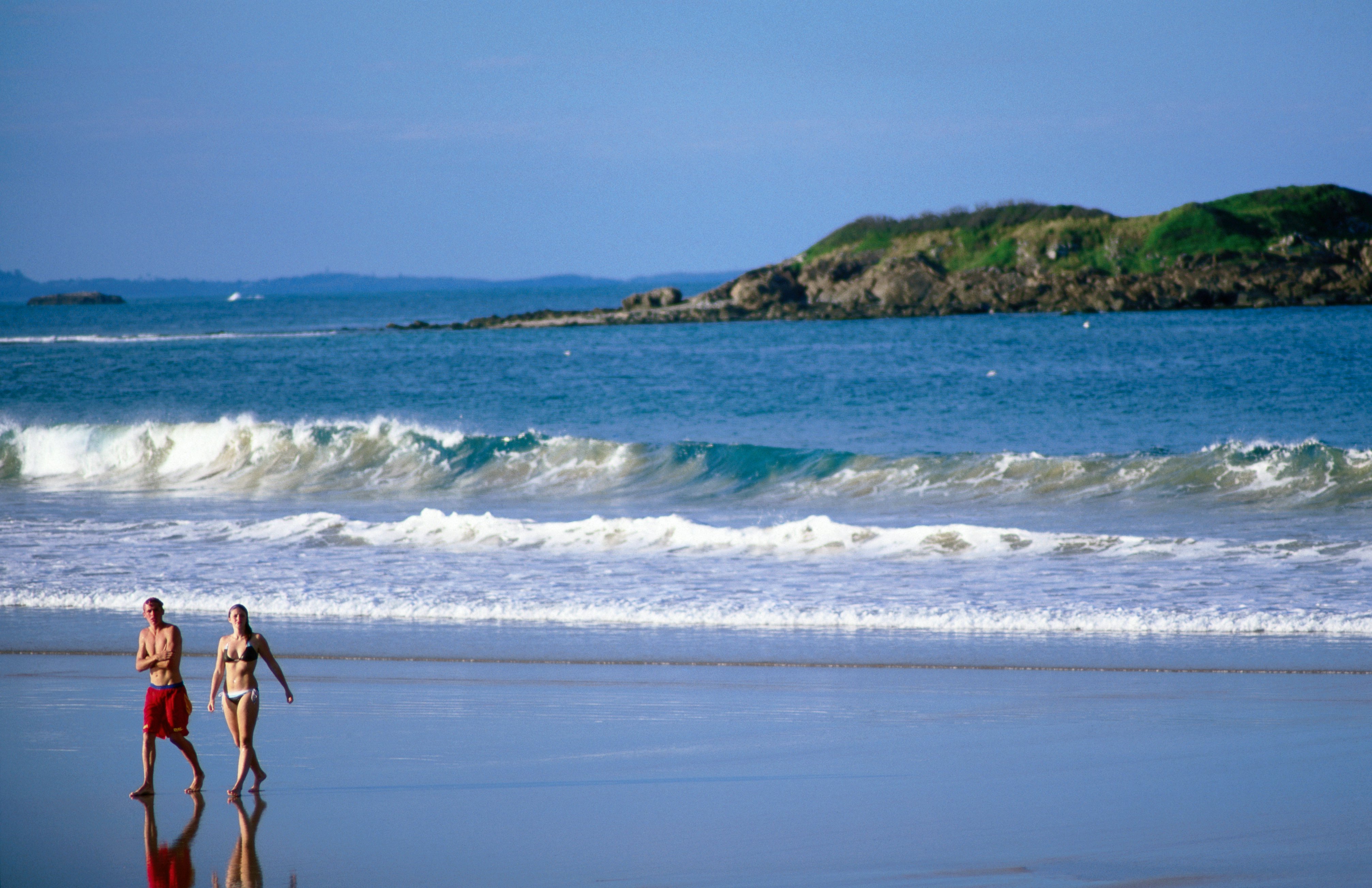 Beachgoers at Park Beach with Little Muttonbird Island in background.