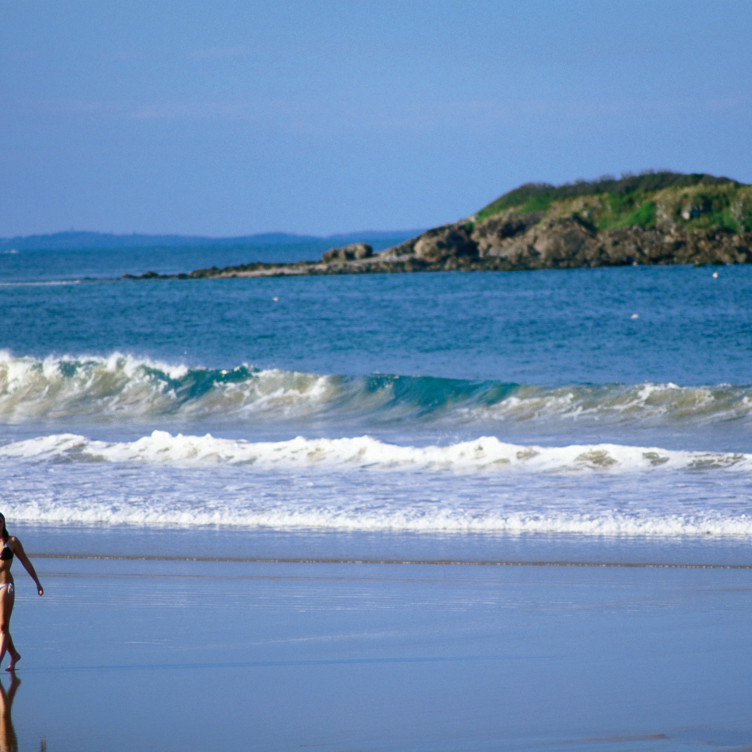 Beachgoers at Park Beach with Little Muttonbird Island in background.