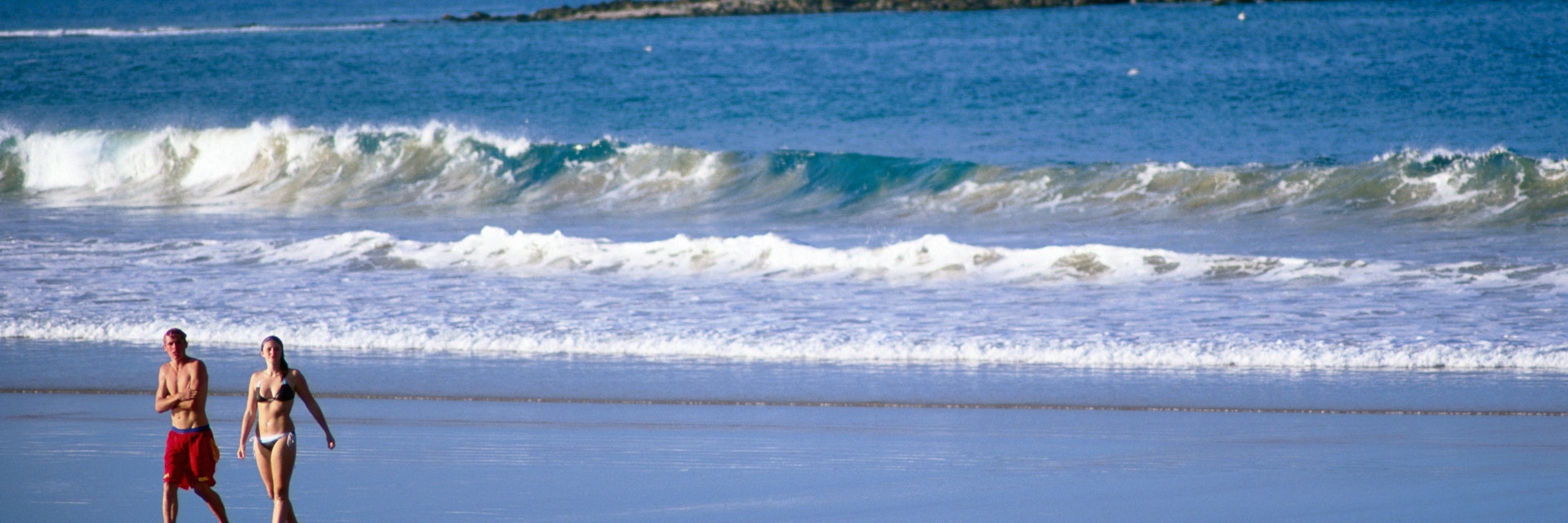 Beachgoers at Park Beach with Little Muttonbird Island in background.