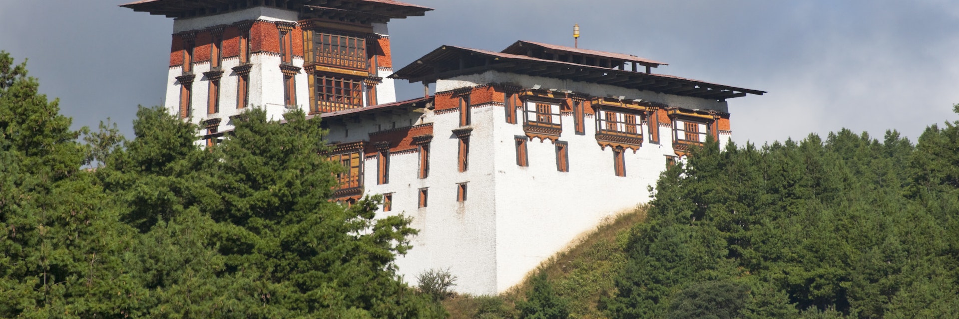Jakar Dzong in mountains.