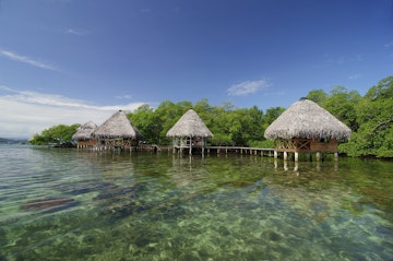 Cabins on the tropical waters of Coral Key, Bastimentos Marine Park.