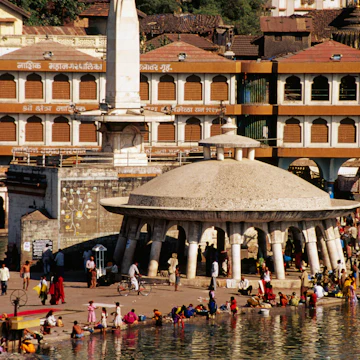 Women and girls washing clothes in holy bathing tank, the Ramkund.