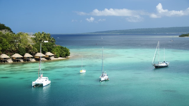 Bungalows on Iririki Island and yachts on Mele Bay from Port Vila.