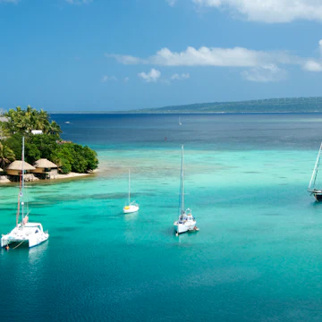 Bungalows on Iririki Island and yachts on Mele Bay from Port Vila.