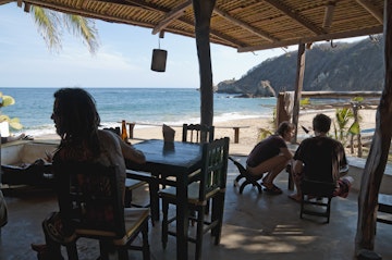 Travelers relaxing at the restaurant at Posada del Arquitecto.