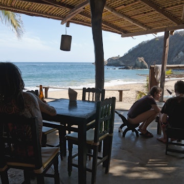 Travelers relaxing at the restaurant at Posada del Arquitecto.