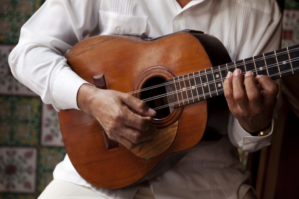 A man playing a guitar in Cuba