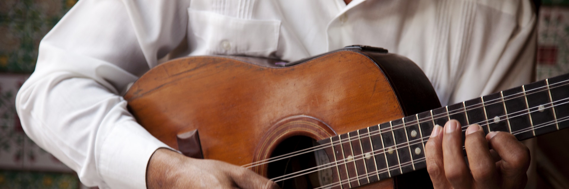 A man playing a guitar in Cuba