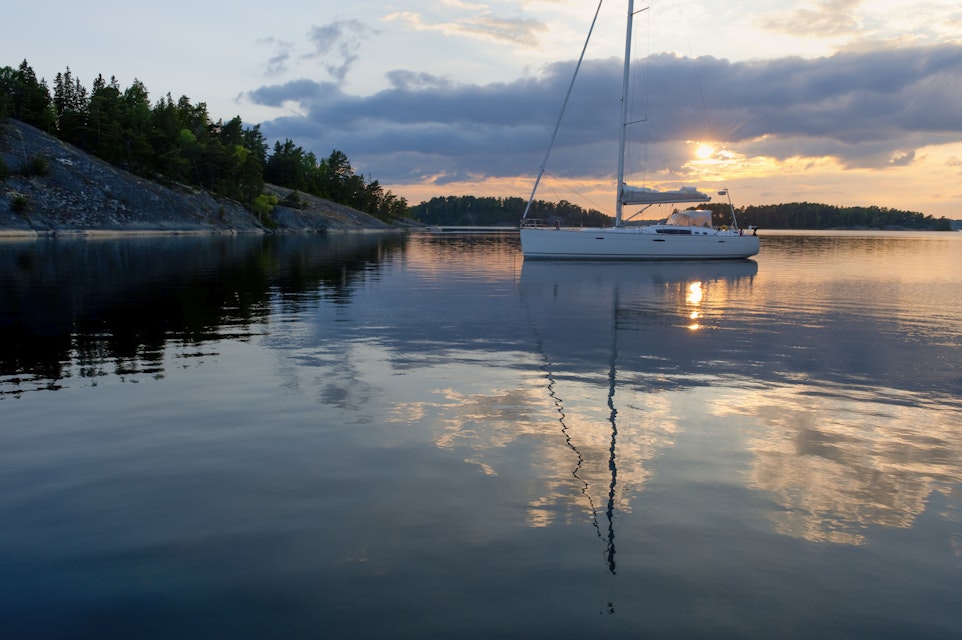 Sunset with sailboat at anchor in the archipelago