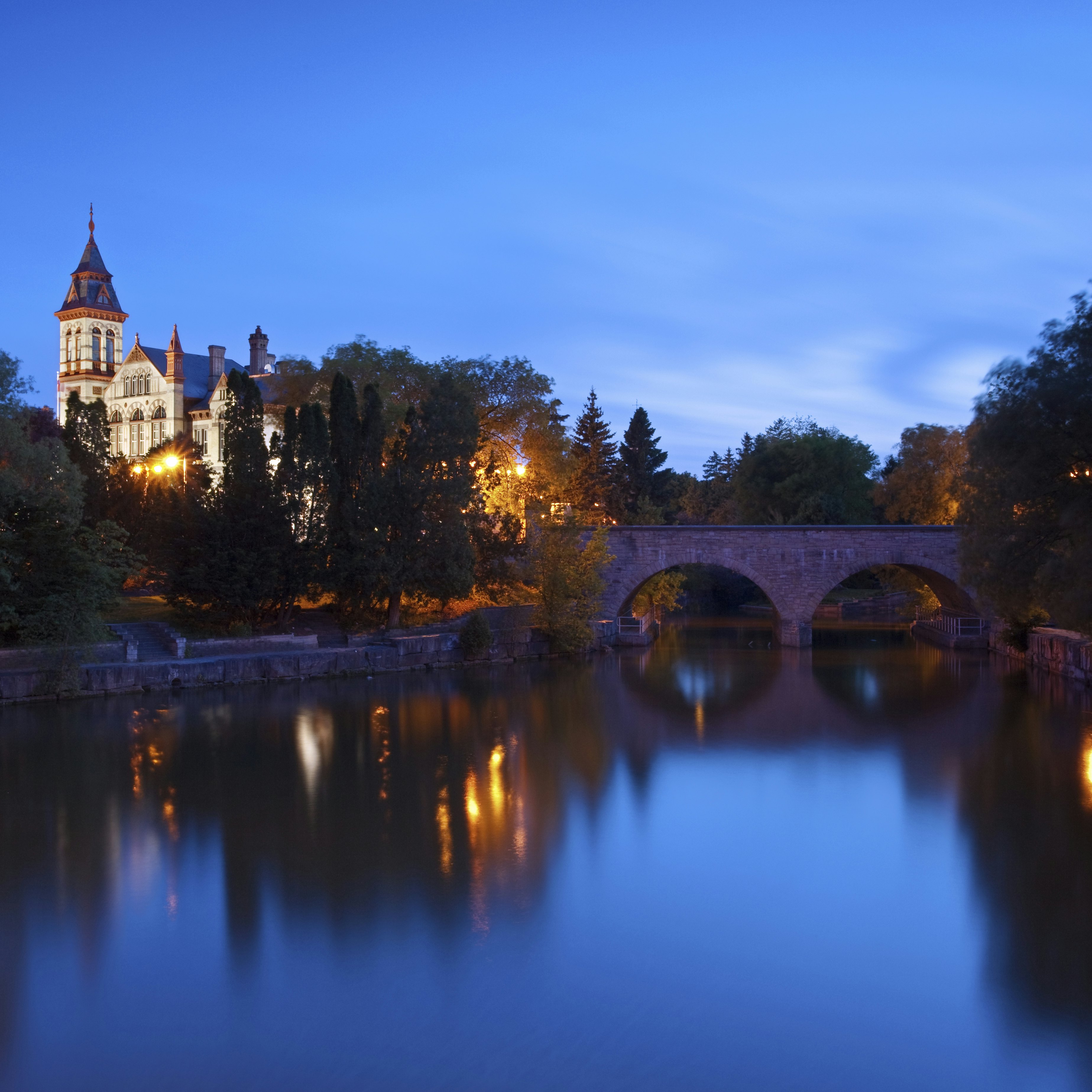 A night view of the Stratford courthouse in Stratford Ontario with the Avon river in the foreground