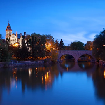 A night view of the Stratford courthouse in Stratford Ontario with the Avon river in the foreground