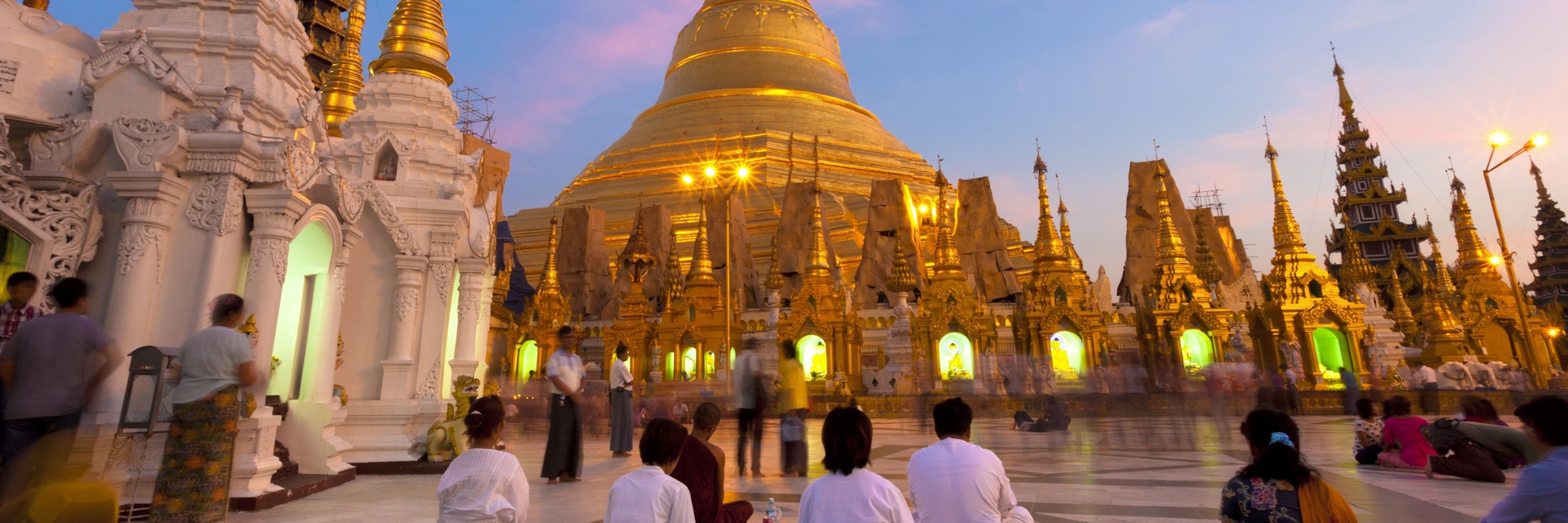 Shwedagon Paya (Pagoda) at dusk with Buddhist worshippers praying, Yangon (Rangoon), Myanmar (Burma), Asia
