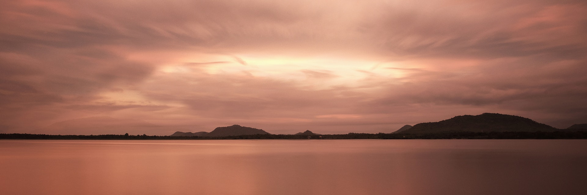 Artificial lake Tissa Wewa with clouds and long time exposure, Hambantota District, Tissamaharama, Sri Lanka