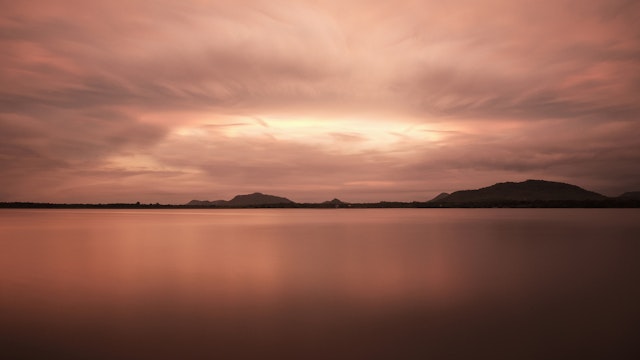 Artificial lake Tissa Wewa with clouds and long time exposure, Hambantota District, Tissamaharama, Sri Lanka