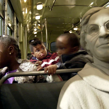 MEMPHIS, TN - JANUARY 19: Aja Robertson, 7, looks out the window of the Rosa Parks bus exhibit at the National Civil Rights Museum January 19, 2004 in Memphis, Tennessee. The museum's attendance swelled to about 9,500 visitors on Martin Luther King Day. (Photo by Mike Brown/Getty Images)