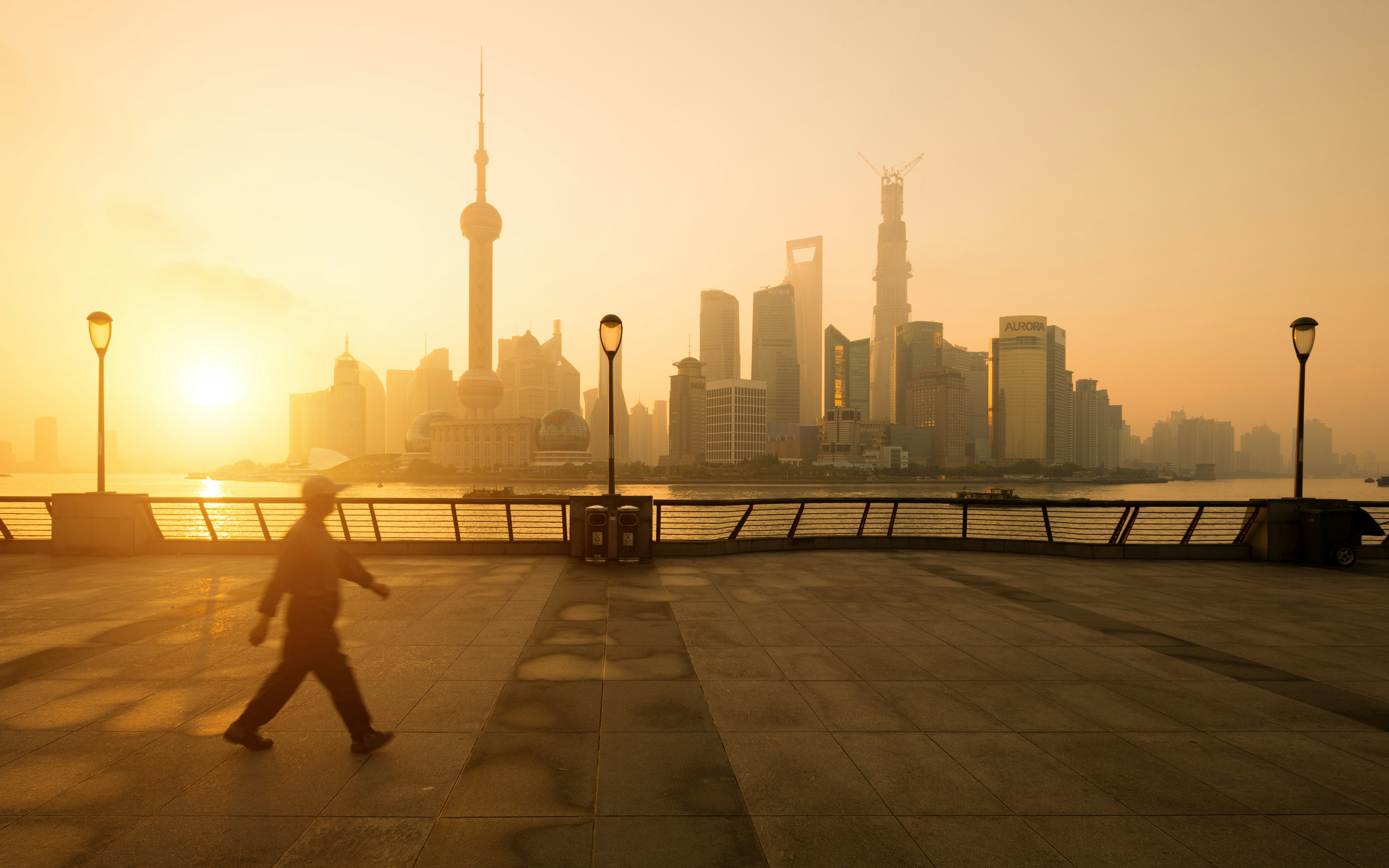 Sunrise on Bund Shanghai with walking man