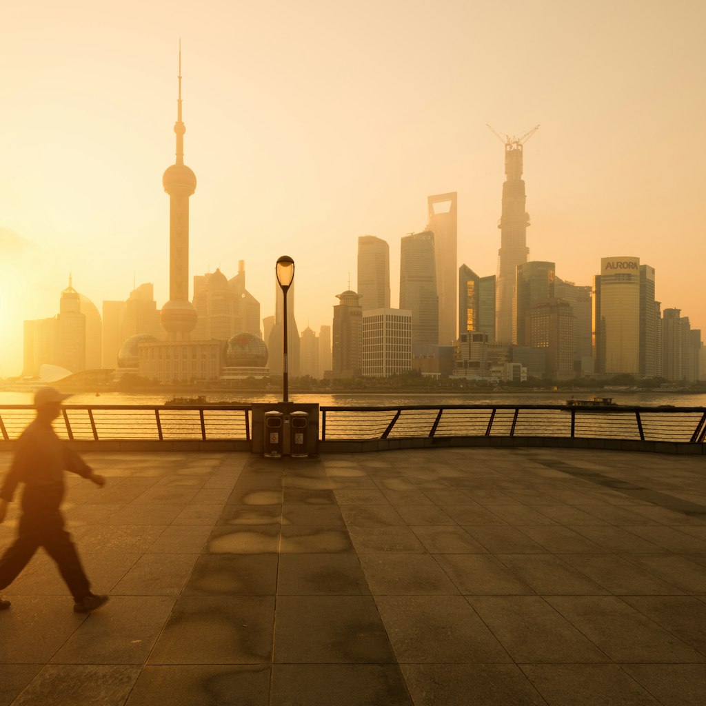Sunrise on Bund Shanghai with walking man